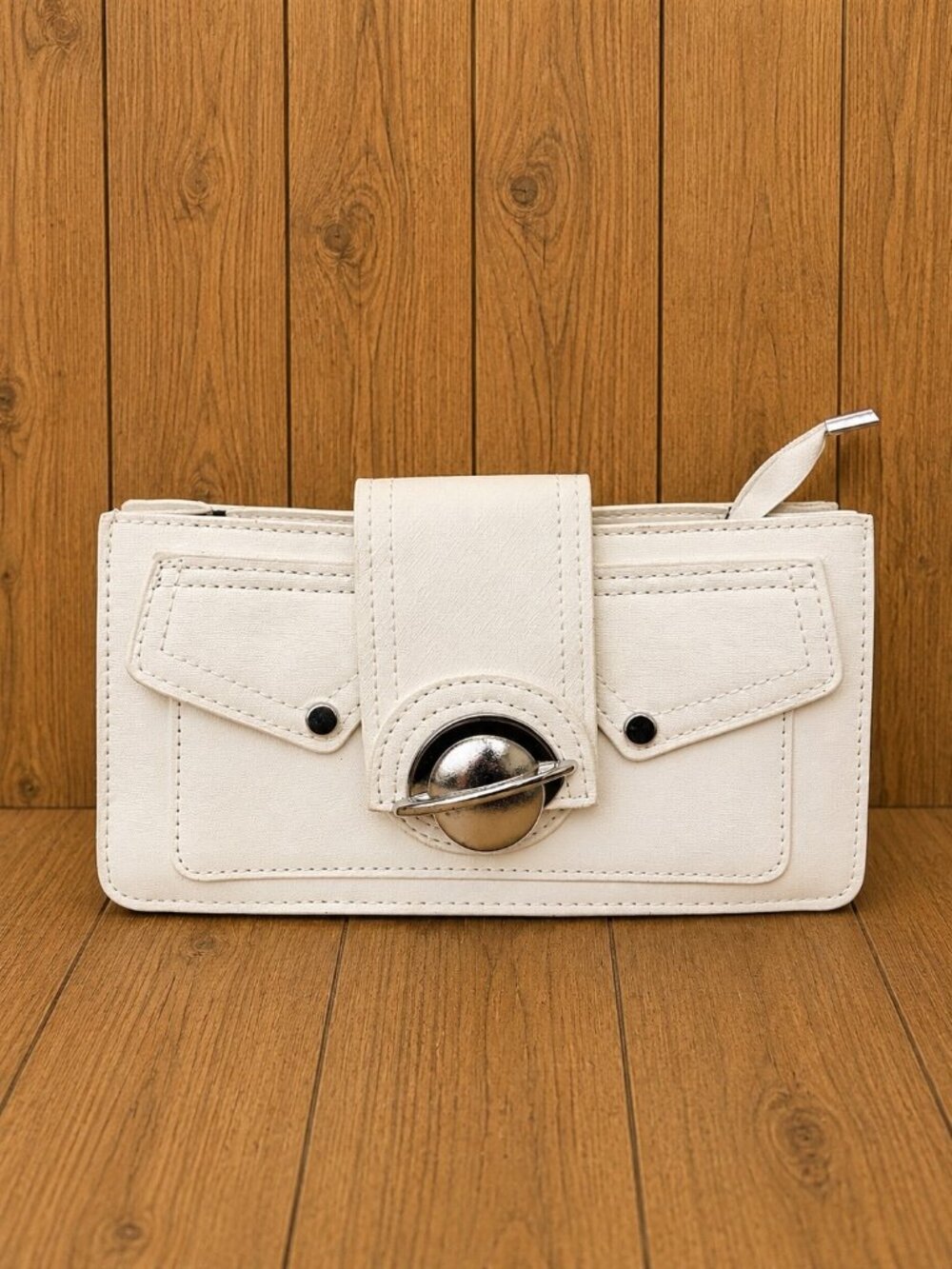 White rectangular clutch-style handbag featuring front pocket detailing
